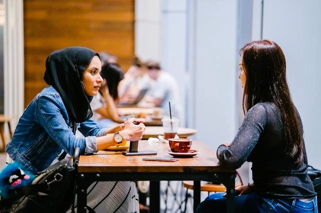 Girlfriends sit in a cafe